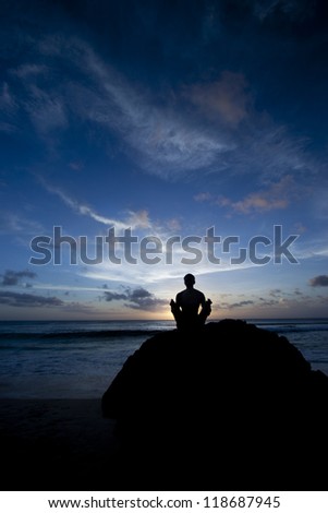 Man on rock practice the yoga/Practice yoga (zen meditation) on beach/Yoga practice on beach