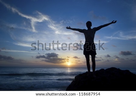 Man on rock practice the yoga/Happy man practice yoga on beach/Yoga practice on beach (freedome)