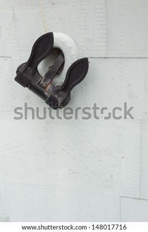 An anchor on the side of a ship