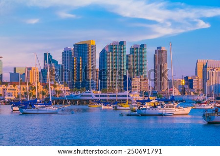 Skyscrapers of San Diego Skyline, waterfront, boats and harbor with pink glow of dusk light, CA