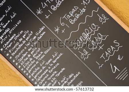 Spanish tapas advertised on a blackboard.