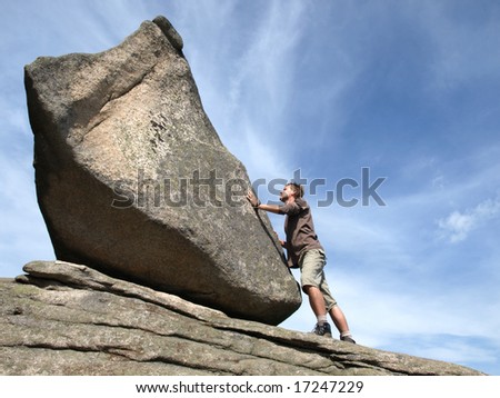 Determination - young man against the rock.