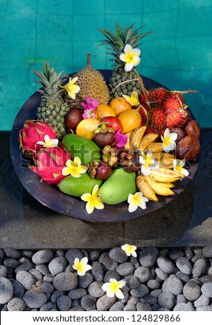 Tropical Exotic fruits near the swimming pool in a basket: Mango, Pineapple, Avocado, Dragon fruit, Durian, Banana, Rambutan, Passion fruit, Snake fruit and Mangosteen, shoot on Bali island Indonesia