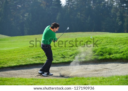Golfer Sand trap, Golfer chipping the ball from sand trap