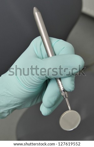 Dental angled mirror, Dentist hand with gloves
