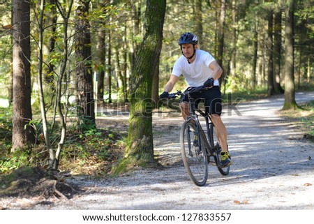 A mountain biker riding through a trail.