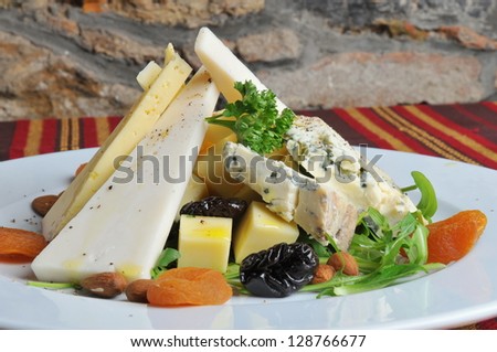 Cheese plate, Gorgonzola, parmigiano, pecorino cheese, with dry fruits, typical Italian food