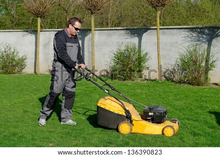 lawn mower man working on the backyard