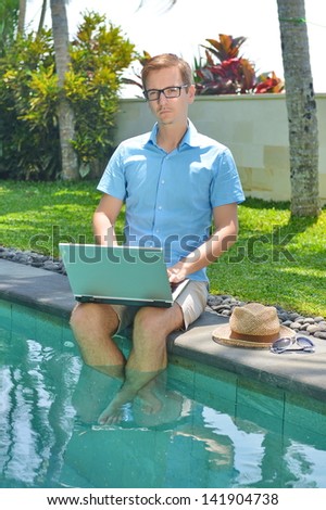 Young Businessman working with Computer on vacations