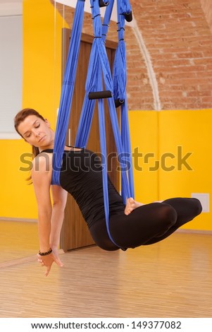 Woman doing anti gravity Aerial yoga / pilates exercise