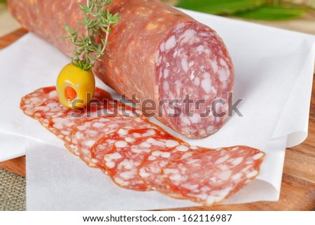 Salami sliced on wood background