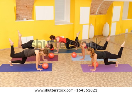 Aerobics pilates class with yoga balls in a row on fitness class