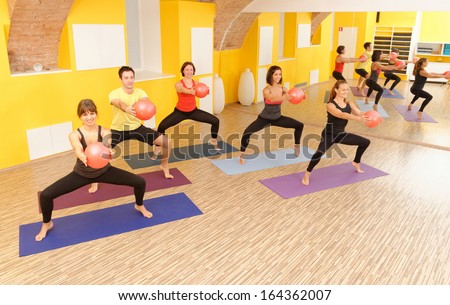 Aerobics pilates class with yoga balls in a row on fitness class