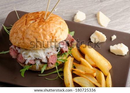 Gourmet burger with roast beef, potato and parmesan cheese, close up