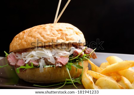 Gourmet burger with roast beef, potato and parmesan cheese, close up
