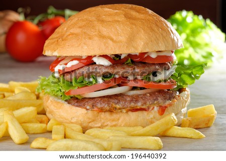 Big juicy double burger with french fries