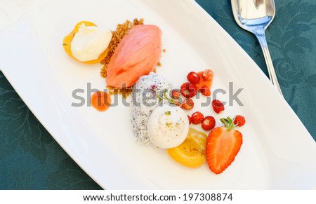 Fine dining dessert, Strawberry ice cream, poppy seed mousse and fresh fruit