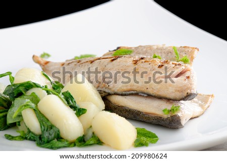 Grilled white fish fillets with potato and spinach