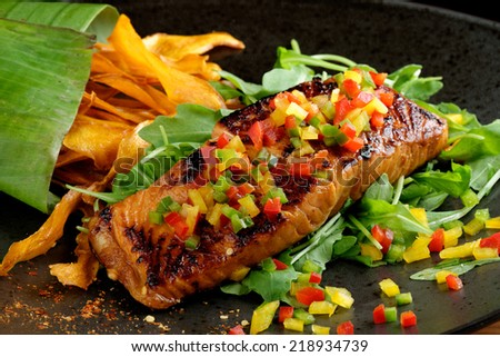 Fried fillet of red fish salmon with roasted vegetables, sweet potato, zucchini, pepper, beautiful dish / Fusion food