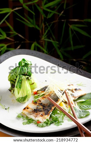 Grilled sea bass fillet with ginger, fresh peppers and pak choy / Fusion food