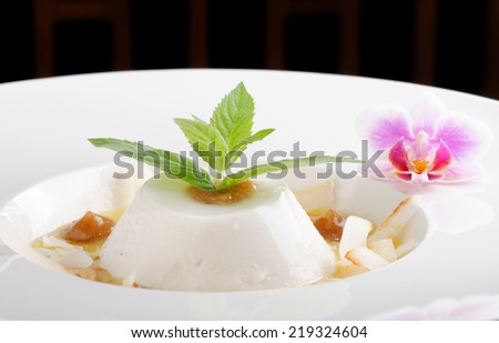 Coconut panna cotta with sour mango and date puree / Fusion food