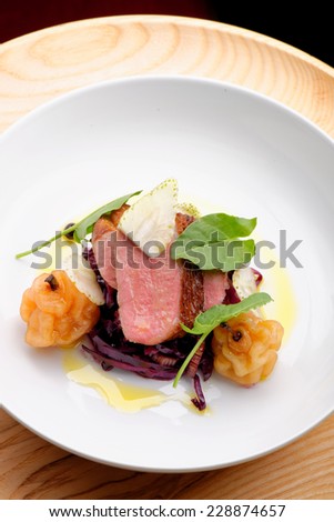Roast duck, red cabbage and dry fruits in fine dining restaurant