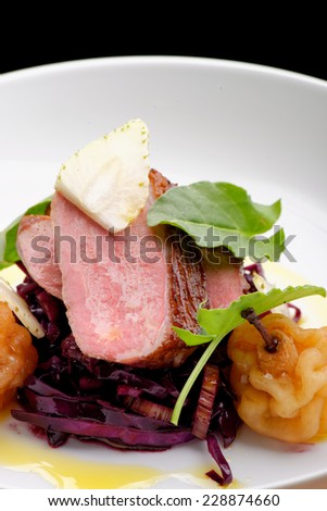 Roast duck, red cabbage and dry fruits in fine dining restaurant