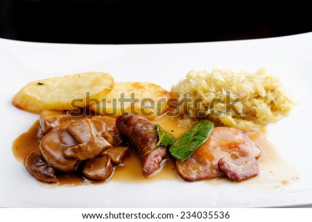 German food,  with sausages, steaks, potato and cabbage