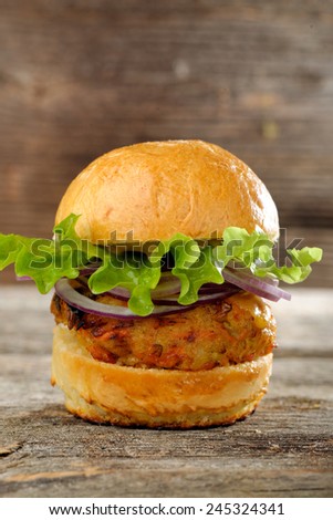 Vegetarian lentil burger in wholewheat bun with lettuce and cucumber (Selective Focus, Focus on the front of the sandwich)