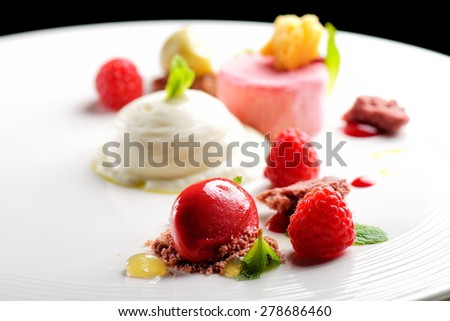 Fine dining dessert, Raspberry Parfait, ice cream, white chocolate mousse and spices