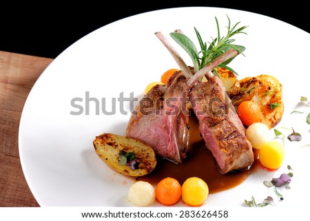 Fine dining, roasted Lamb chops with potato, rosemary and vegetable sauce