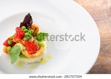 Fine dining, Fried Octopus on potato puree, green peas and fresh strawberries