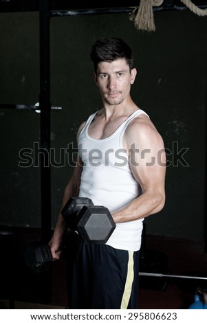 Fitness Trainer training his bicep at the gym