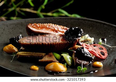 Haute cuisine/Asian fusion, roasted duck with plums and shiitake mushrooms