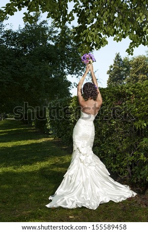 Portrait of beautiful fashionable bride in the park