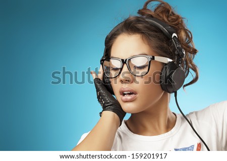 Young woman with headphones listening music .Music teenager girl dancing