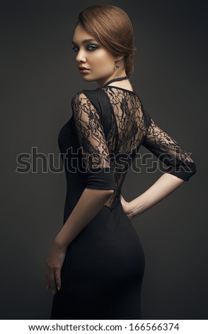 Girl with beautiful hair and makeup in a black evening dress. Evening makeup.
