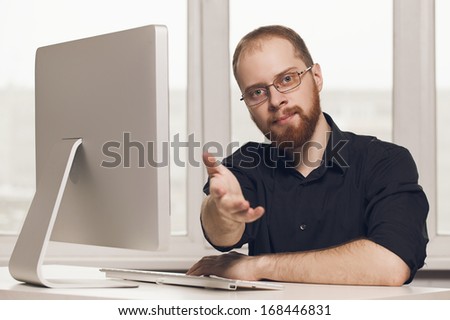cute young man with glasses at the computer
