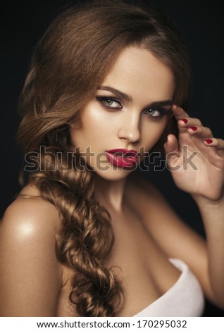 Beautiful girl with red lips. Red lipstick. Red manicure. long hair