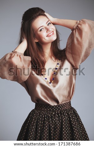 Beautiful girl in fashionable clothes. Studio portrait. Young, tender,