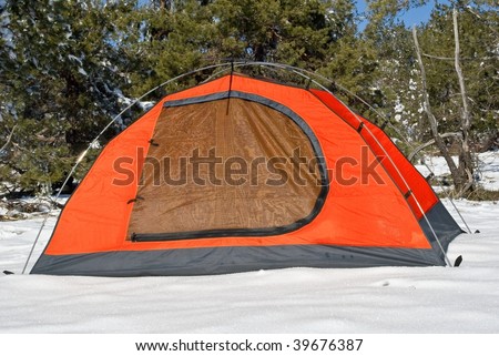 red touristic tent in a snow