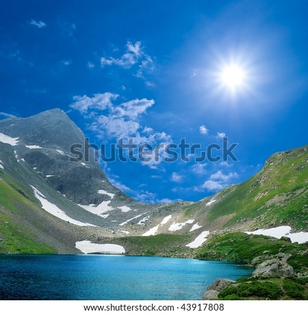lake in a mountains under a sun
