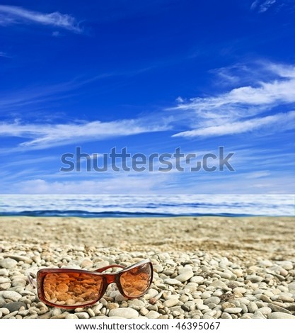 sun glasses on a sea coast