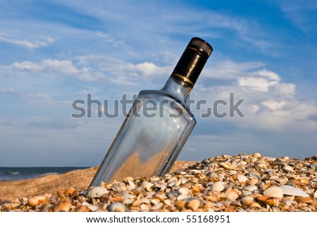 bottle in a sand on a sea coast