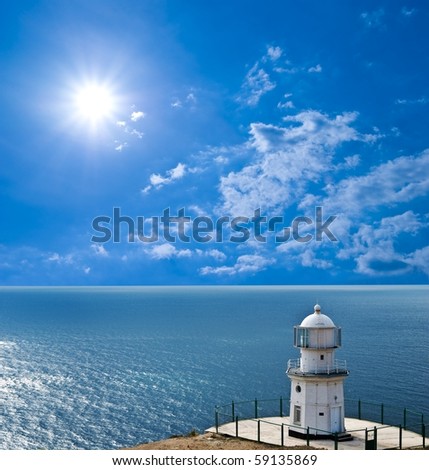 lighthouse on a marine cape under sparkle sun