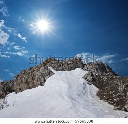 snowbound mountain top under a sparkle sun