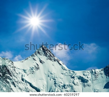 sparkle sun above a snowbound rocks