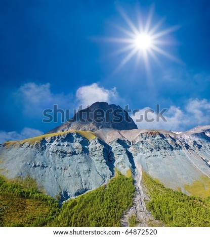 sparkle sun above a mountain top