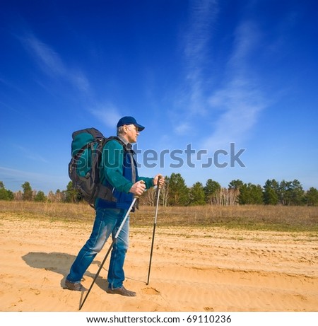 man walking in a sand desert