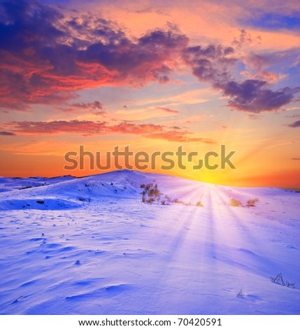 sunset in a winter snowbound plain